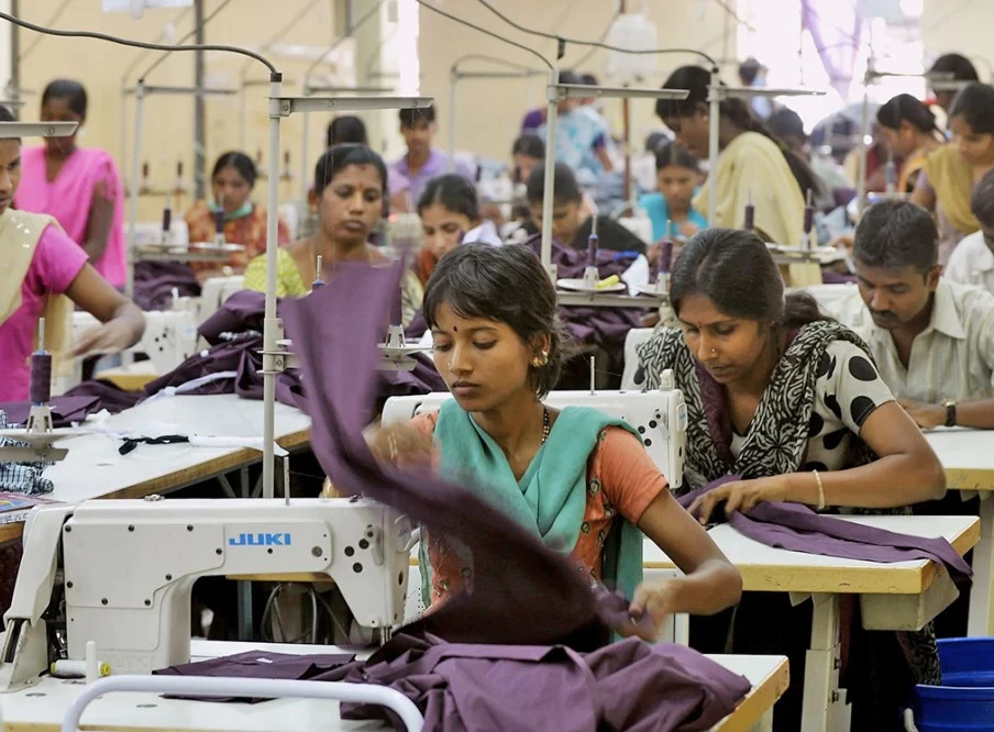 Garment factory workers at sewing machines Tirupur